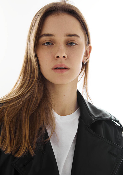 Portrait of beautiful young fashion model girl with leather jacket and white t-shirt on white. - Foto, Imagen