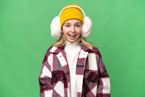 Young  English woman wearing winter muffs over isolated background with surprise facial expression - Foto, immagini