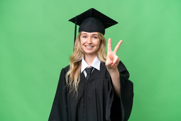 Mladá univerzita Angličtina absolvent žena přes izolované pozadí s úsměvem a ukazující vítězství znamení - Fotografie, Obrázek