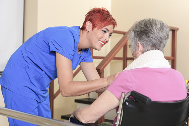 Elderly lady with her physiotherapists in a hospital - Fotografie, Obrázek
