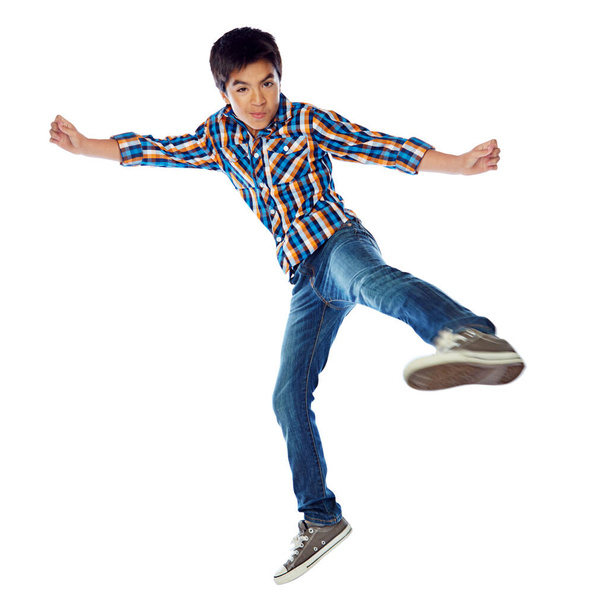 Time to spring into action. Studio shot of a young boy jumping energetically against a white background - Фото, изображение