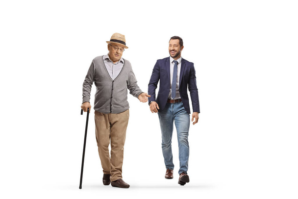Elderly man walking and talking to a younger man isolated on white background - Foto, afbeelding