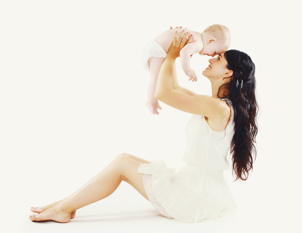 Beautiful mom with her cute baby having fun together  - Фото, изображение