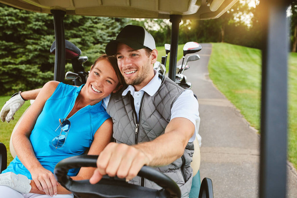 Happy golfers. an affectionate young couple spending a day on the golf course - Foto, immagini