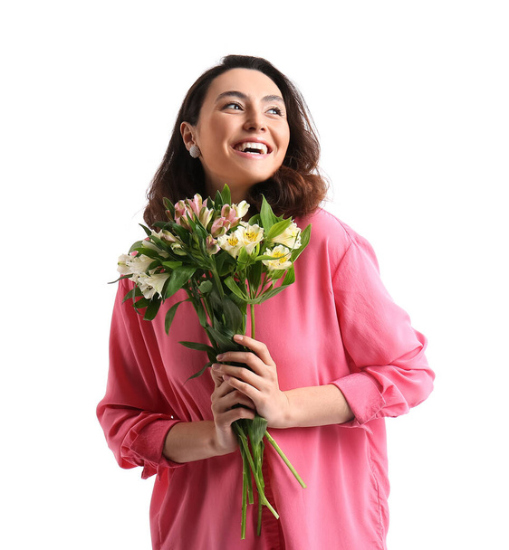 Young woman in pink shirt with alstroemeria flowers on white background - Fotoğraf, Görsel