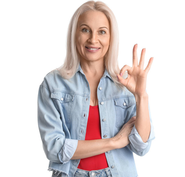 Mature woman showing OK on white background - Photo, Image