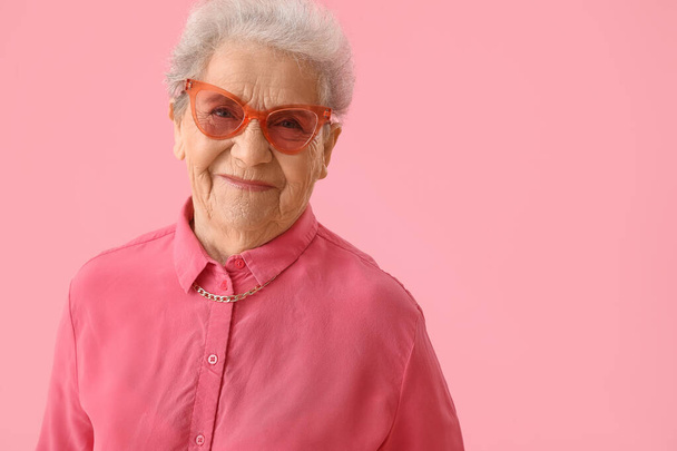 Senior woman on pink background, closeup - Fotografie, Obrázek
