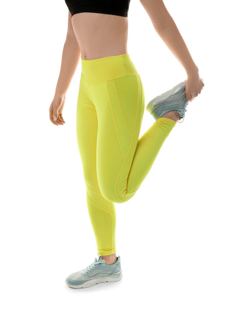 Sporty young woman in leggings on white background - Fotó, kép