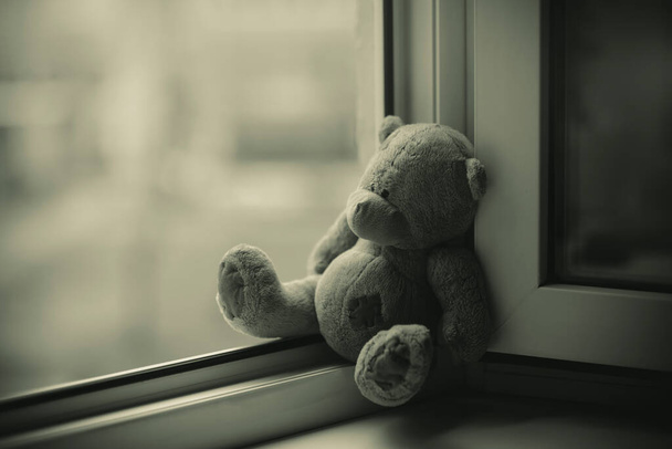Children toy teddy bear edge open window.Concept of accidents with children - Zdjęcie, obraz