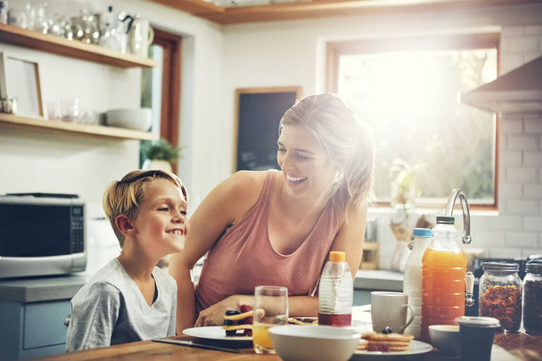 No hay nada que un panqueque no pueda arreglar. una mujer sentada con su hijo mientras desayuna - Foto, imagen