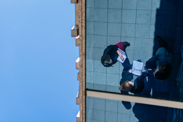 Reflection of three businesswomen working together outdoors - 写真・画像