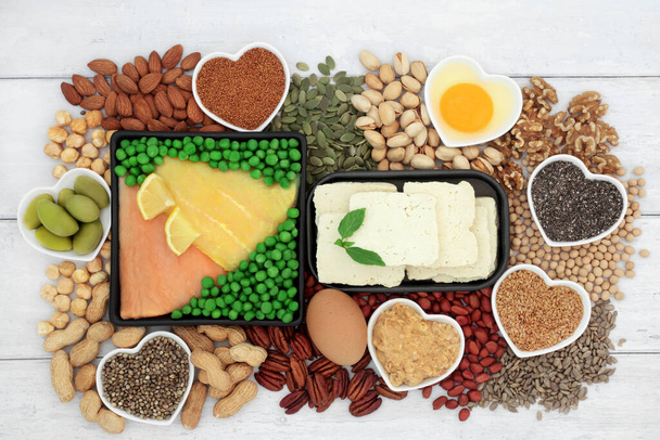 Low cholesterol healthy heart food high in essential fatty acids unsaturated good fats. Seafood, dairy, vegetables, legumes, nuts, seeds. High in fibre, omega 3, protein antioxidants.  - Photo, Image