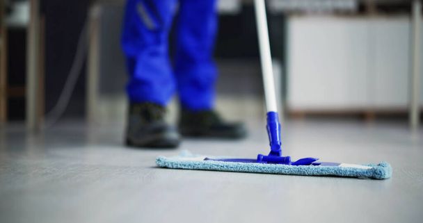Portrait Of Happy Male Janitor Cleaning Floor At Office - Valokuva, kuva