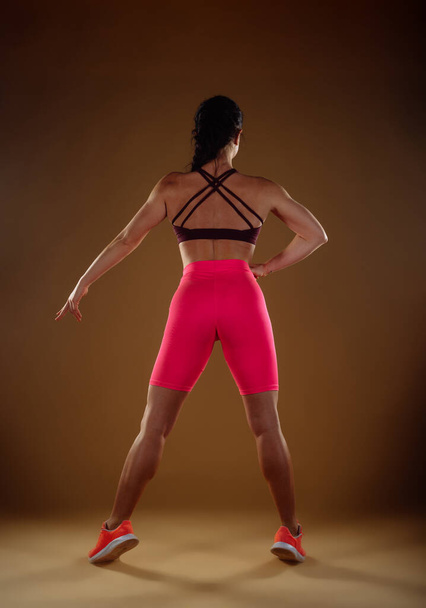 Une photo de vue arrière de la femme en forme exerçant ses muscles du mollet - Photo, image
