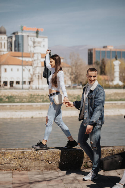 En iyi arkadaşlar şehrin göbeğindeki nehrin kenarında yürüyor ve eğleniyorlar. - Fotoğraf, Görsel