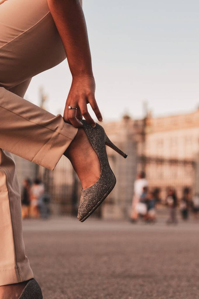 A vertical shot of a woman wearing elegant fashionable heels on the street - Photo, image