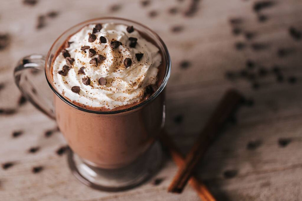 A closeup shot of a cup of hot chocolate on the wooden background - 写真・画像