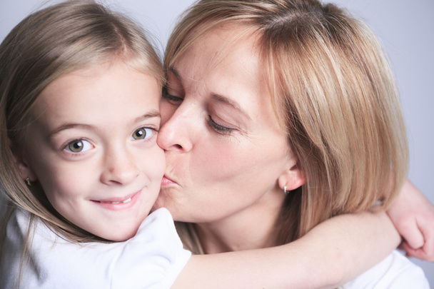 A mother with is daughter over gray background - Photo, Image