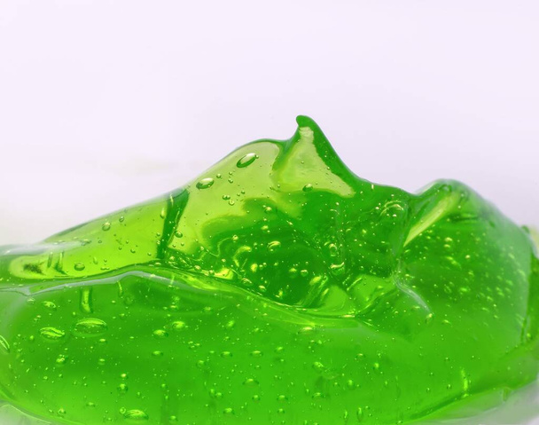 A closeup shot of a green gel texture of aloe isolated on a white background. - Photo, Image