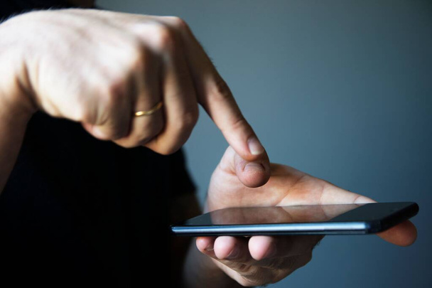 A man pointing out his finger to the blank screen of the modern smartphone - Photo, image