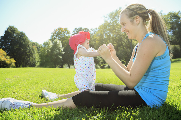A mother training with baby on a summer day - Foto, Imagen