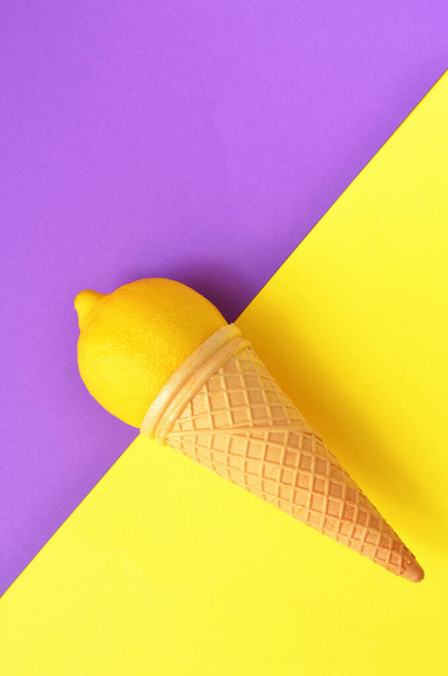 ワッフルコーンの中のフレッシュレモン色のコントラストが鮮やかな背景 - 写真・画像