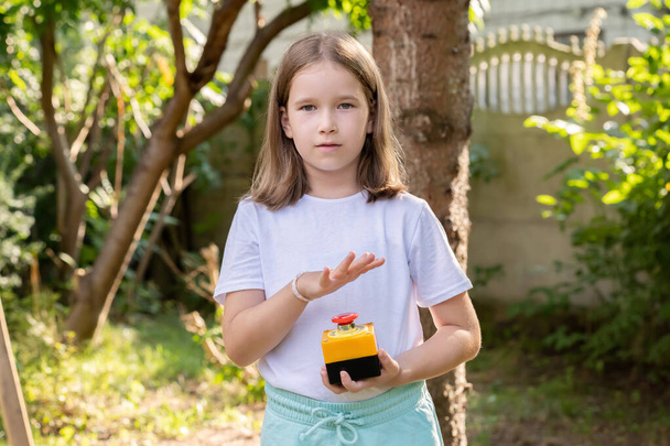 Elementary school age girl about to press a big red industrial emergency stop button, alarm, stopping action, urgency attention simple concept, one person. Advertisement sales, deals, discounts, alert - Photo, Image
