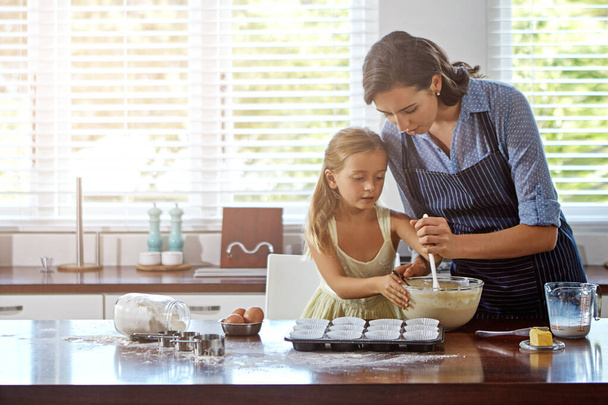 Passing on the family recipes. a mother and her daughter baking in the kitchen - Photo, Image