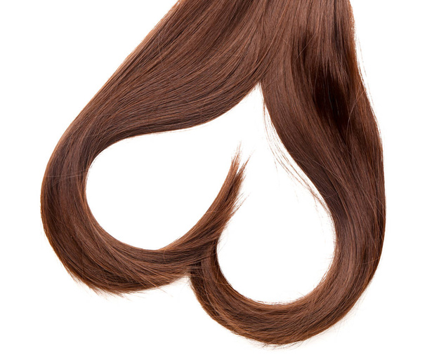 Heart made of brown hair on white background - Foto, Imagem