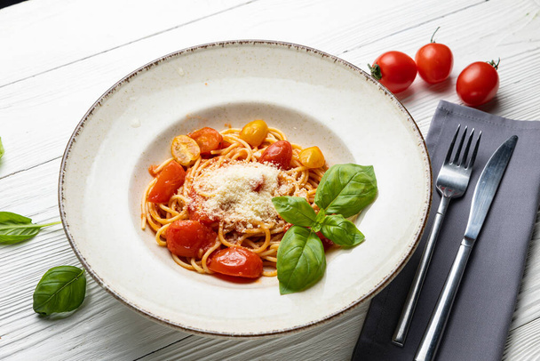 delicious pasta in a plate on a white wooden table. close-up - Foto, immagini