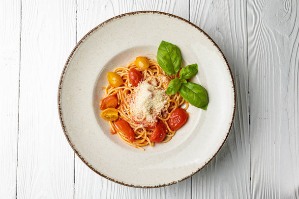 delicious pasta in a plate on a white wooden table. close-up - Фото, зображення