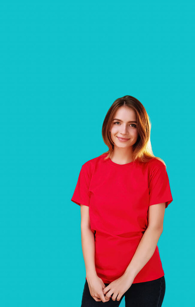 Cheerful woman. Good mood. Happy expression. Satisfied girl in red T-shirt looking smiling at camera isolated on cyan blue copy space background. - Valokuva, kuva