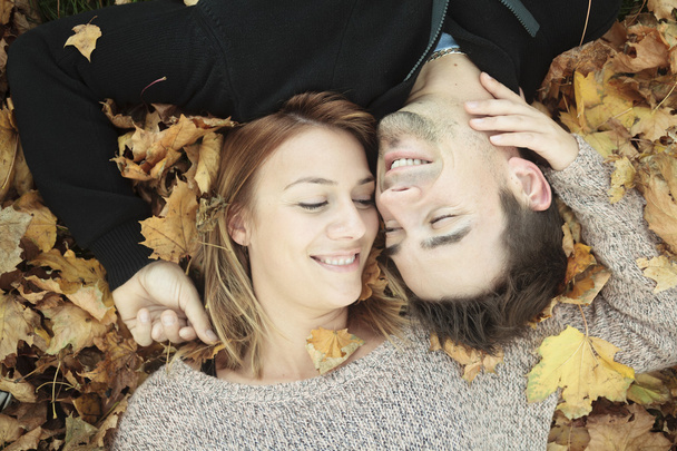 A Young happy couple in autumn season - 写真・画像
