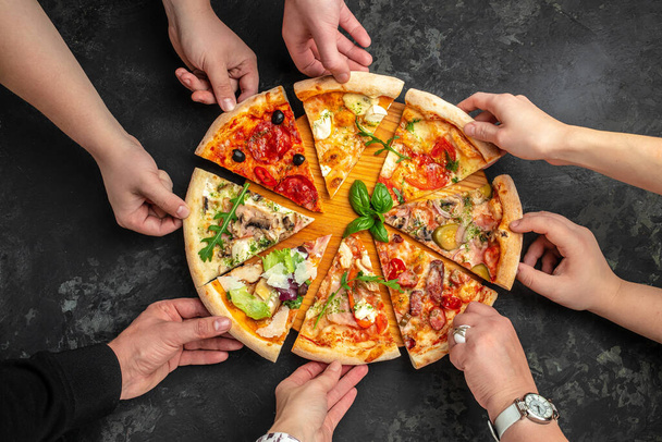 Various taste type pizza slices with different traditional filling in hands. menu, dieting, cookbook recipe top view. - Photo, Image