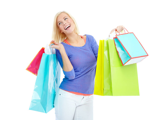 Oh glorious shopping, how I love you. An excited young woman holding shopping bags while isolated on a white background - Photo, Image