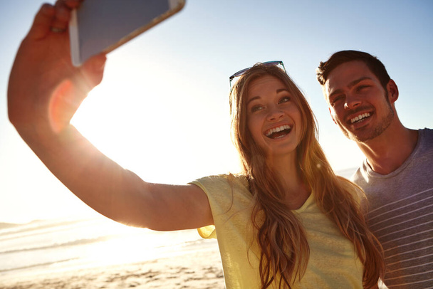Memorable moments on the beach. an affectionate young couple taking a selfie on the beach - Photo, Image