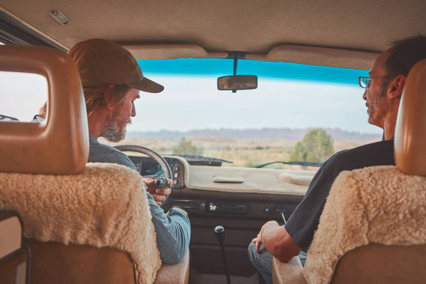 Hitting the road with my best bud. two men smoking together while out on a road trip - Photo, Image