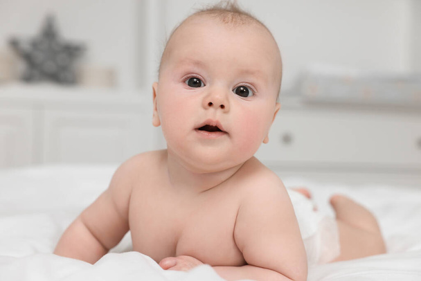 Cute baby lying on white bed at home - Fotoğraf, Görsel