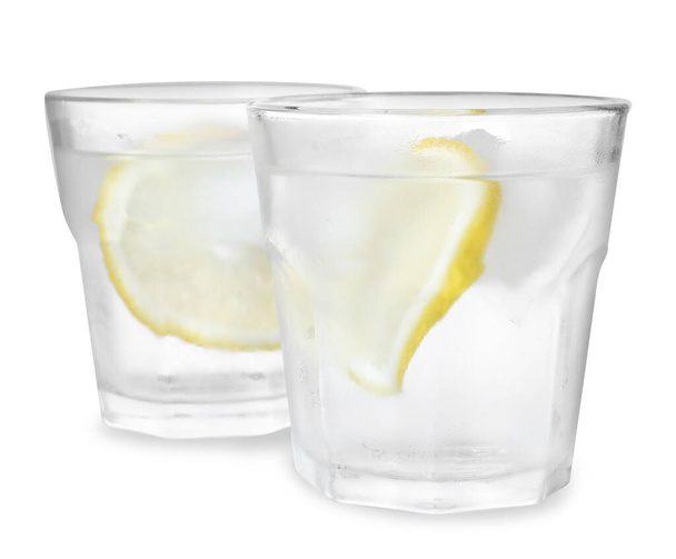 Glasses of vodka with ice and lemon isolated on white - Photo, image