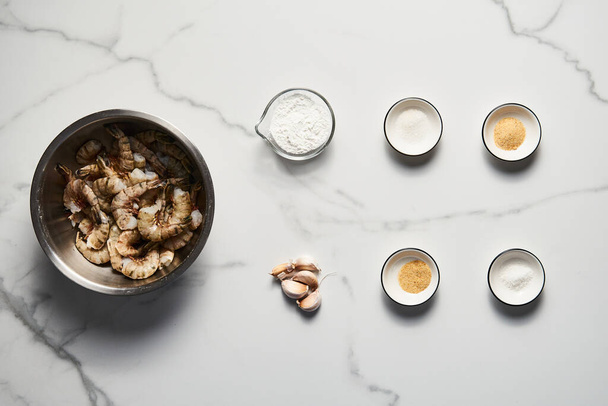Crispy Pan fried tiger shrimps or prawns with garlic ingredients list on white marble background. Top view food photo. High quality photo - Photo, Image