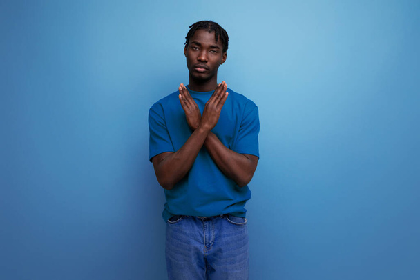 young dark skinned man with crossed arms over isolated background. - Photo, Image