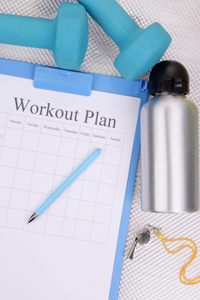 Workout plan and sports equipment top view close-up  - Foto, afbeelding