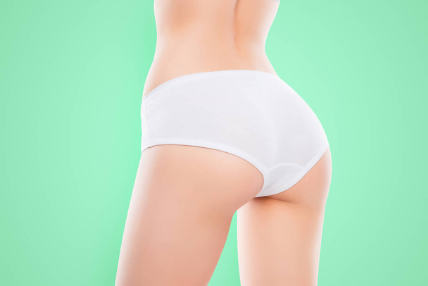 Close up photo of fit womans ass with perfect ideal skin in white lingerie isolated over white background result of anti cellulite cream scrub. Wellness wellbeing spa salon concept. - Foto, immagini