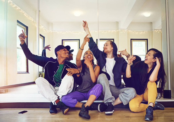 Mad love for their dance crew. a group of young friends hanging out in a dance studio - Photo, Image