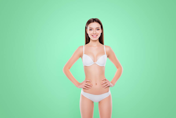 Nutrition lifestyle enhancement purity lifting procedure injection concept. Portrait of thin attractive girl with soft smooth skin holding hands on waistline isolated on white background. - Φωτογραφία, εικόνα