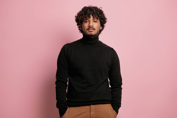 Stylish Indian man looking at camera while standing against pink background - Fotografie, Obrázek