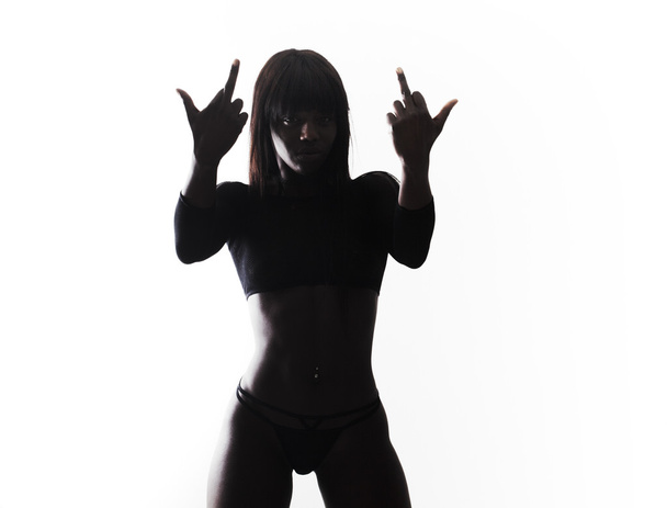 Model silhouette portrait while making middle finger gestures - 写真・画像
