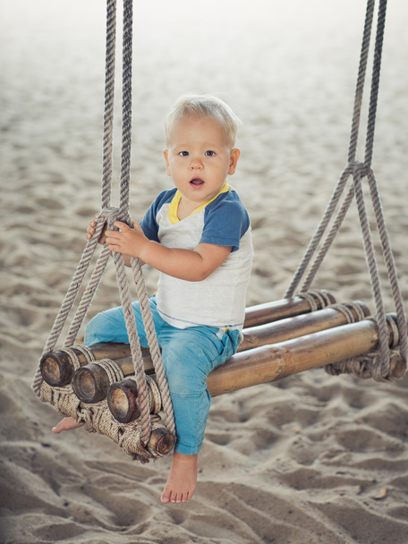 Baby on a swing - 写真・画像