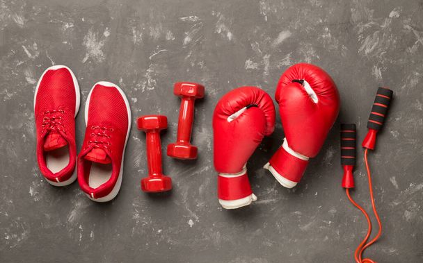 Red sport equipment on concrete background, top view - Photo, Image