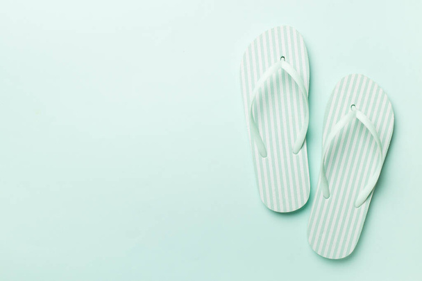 Striped flip flops on color background, top view - Foto, immagini